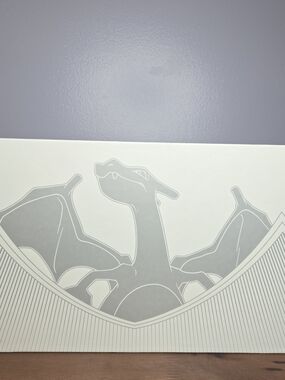 Charizard Box White And Silver, Includes Playmat, Booklet, And Card Containers.